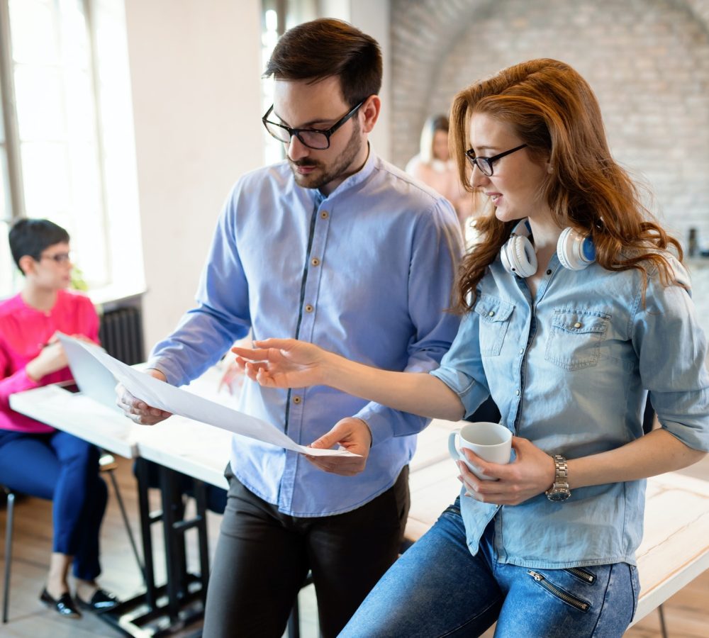 Creative coworkers collaborating on a project in a modern office environment UK & USA